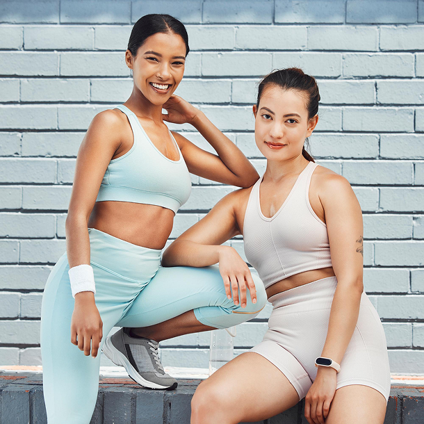 Two women wearing coordinated activewear sets in mint and beige colors